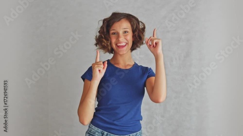 Radiant young beautiful woman expressing complete bliss showing ultimate joy and contentment in a positive moment, studio isolated white background
