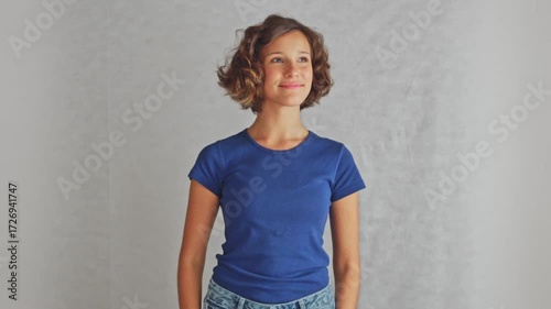 Hopeful young little girl looking upward with optimistic gaze showing motivation for future goals and dreams, isolated white background