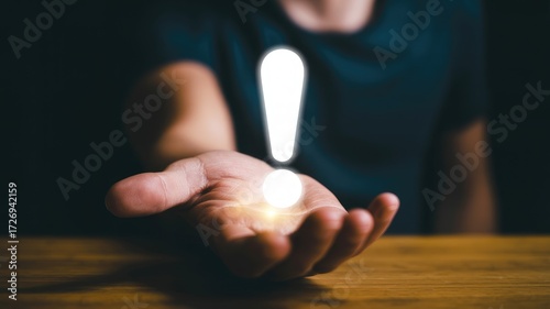 Bright idea or important notice presented in open palm, symbolizing inspiration and discovery