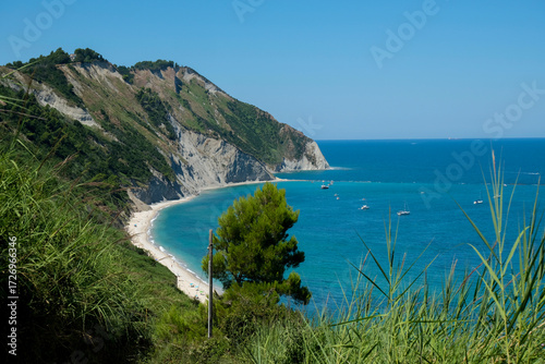 Sunny day at the cliffs in Marche, Italy. Coastline, horizontal line, natural background. turquoise water	
