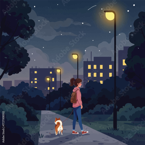 A young woman walks her dog along a park path at night, under the light of city street lamps.