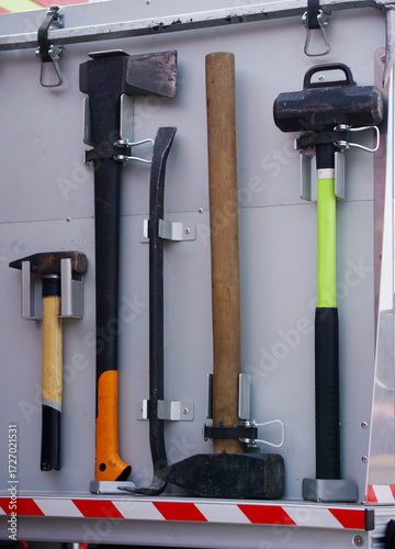 A collection of tools used by rescuers or firefighters, mounted on a wall inside the compartment of a fire engine or rescue vehicle.