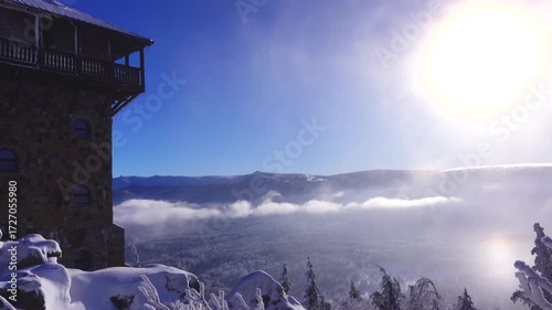 view of Szklarska Poreba in clouds and Krkonose mountains. snow on a High Stone and winter landscape under bright sun. Poland
