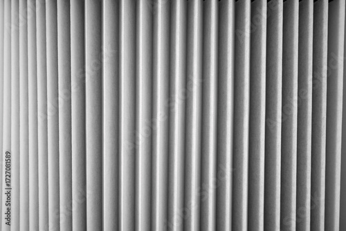 Vertical lines create an interesting texture in a monochrome setting with soft light and shadows