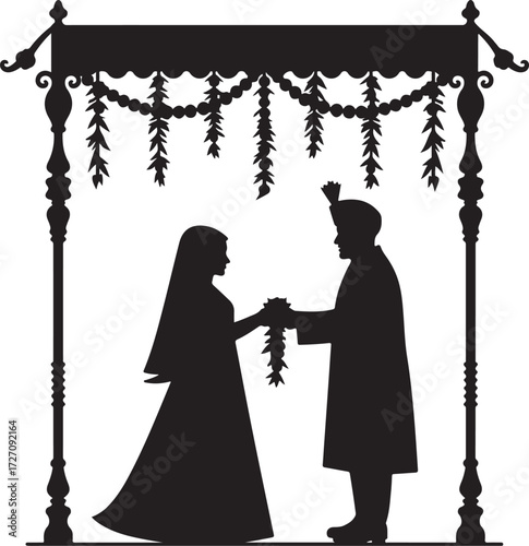 Indian wedding couple exchanging garlands under ornate canopy