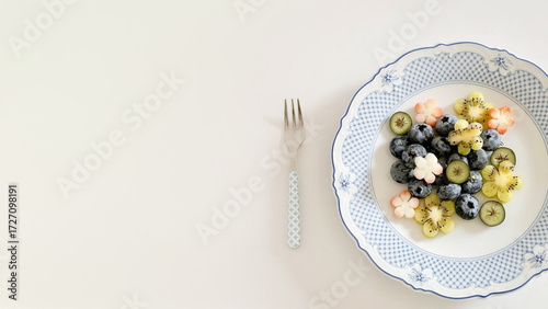 Bild auf Leinwand A delicate symphony of blueberries and star-shaped kiwis, evoking Hanami's flora