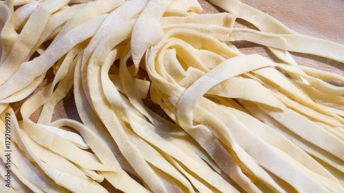 Tableau sur toile Silken strands of fresh fettuccine lie coiled like sunlit rivers, the heart of L