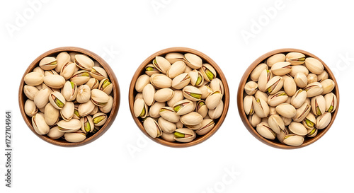 Three bowls of pistachios on black nuts seeds