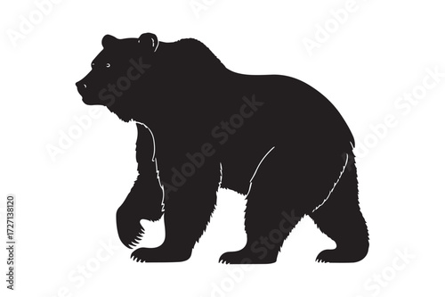 Silhouette of a standing grizzly bear facing left