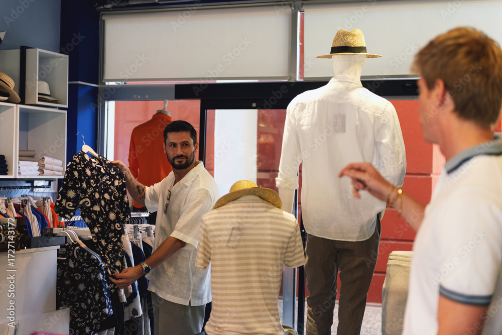 Fototapeta premium Two Men Shopping for Clothes in Store