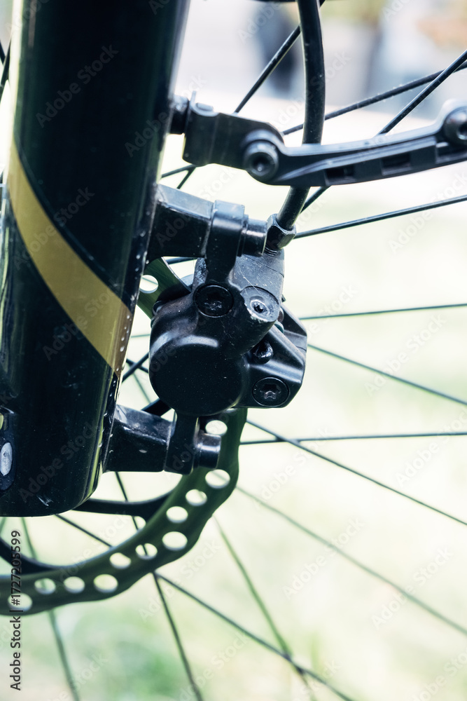 Fototapeta premium Front fork of bicycle with disc brake, detail of modern bike technology
