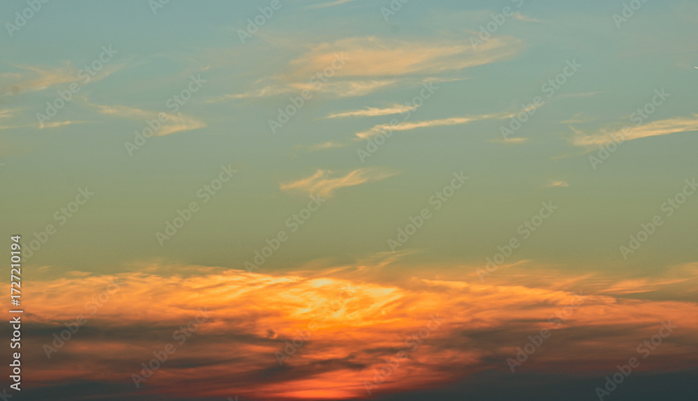 Fototapeta premium Enchanted sky glows behind soft gentle clouds