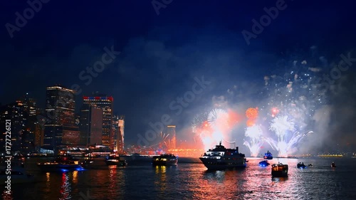 Spectacular firework show on the Independence Day celebration. Night celebration of 4th July in New York, USA. View from the river.