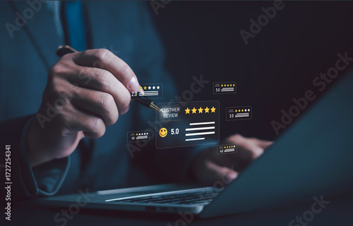 Businessman analyzing online customer reviews with five-star rating system on laptop, concept of digital feedback, service evaluation, satisfaction, reputation management, and marketing strategy.