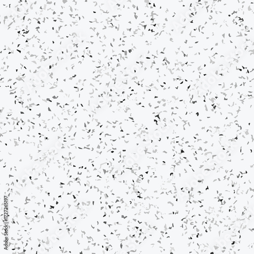 Abstract terrazzo seamless pattern with scattered stone chips in gray and black tones on white background texture.