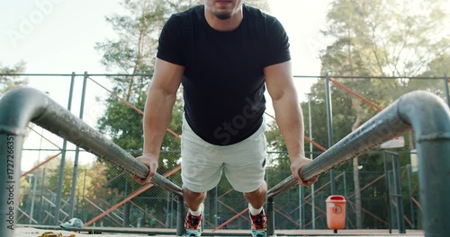 Engaging in the dynamic pushup exercise on parallel bars requires strength, balance, and technique