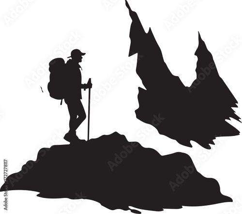 Silhouette of hiker with backpack and trekking pole on rocky terrain