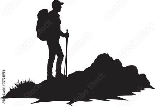Silhouette of hiker with backpack and trekking poles on rocky terrain