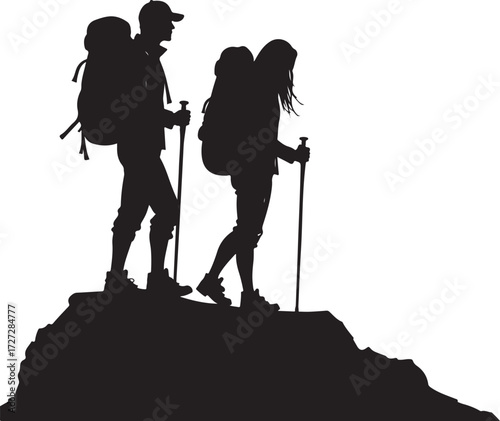 Two hikers with backpacks and poles on a rocky outcrop