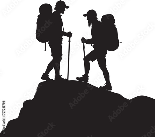Two hikers with backpacks and poles on a rocky summit