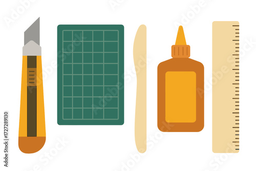 Crafting tools laid out for a project, including a knife, cutting mat, glue, and ruler on a flat surface