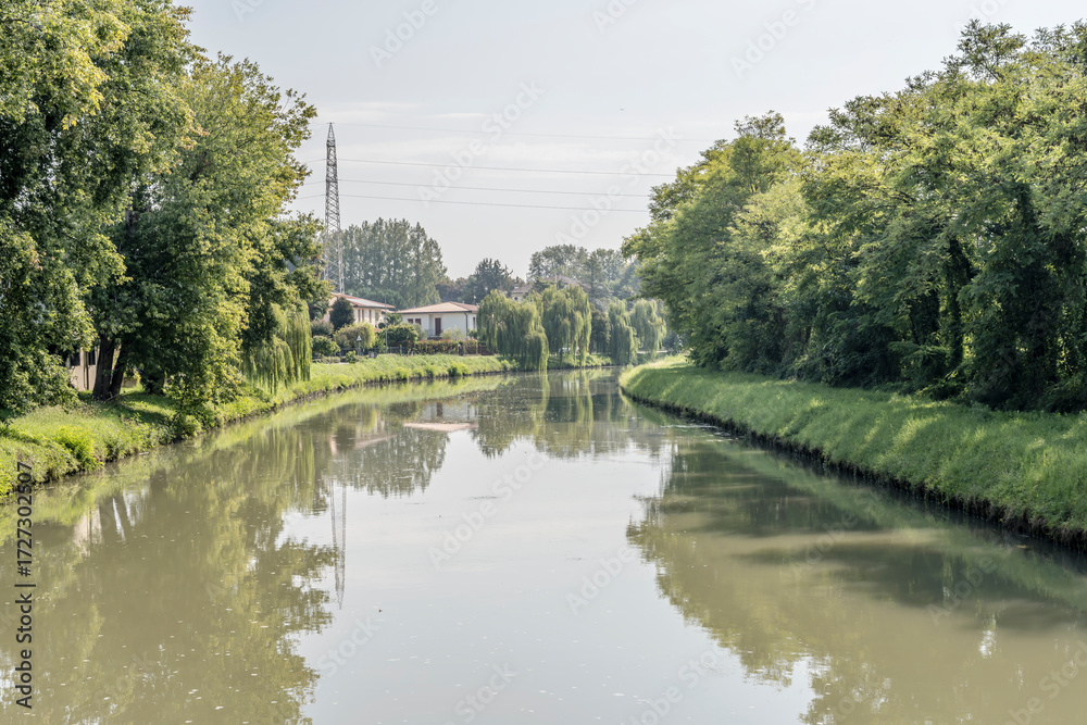 Obraz premium lush vegetation on Brenta canal banks, near Stra, Italy