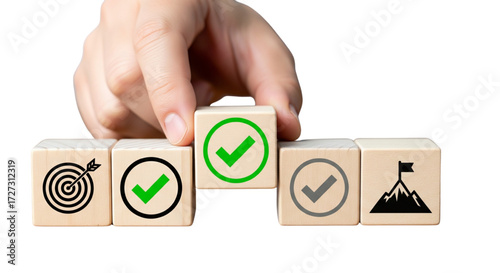 Hand placing a green checkmark wooden block, representing goal setting, achievement, success, and strategic business planning.