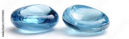 Two smooth, light-blue glass pebbles rest on a white background, showcasing their translucent nature and subtle curves