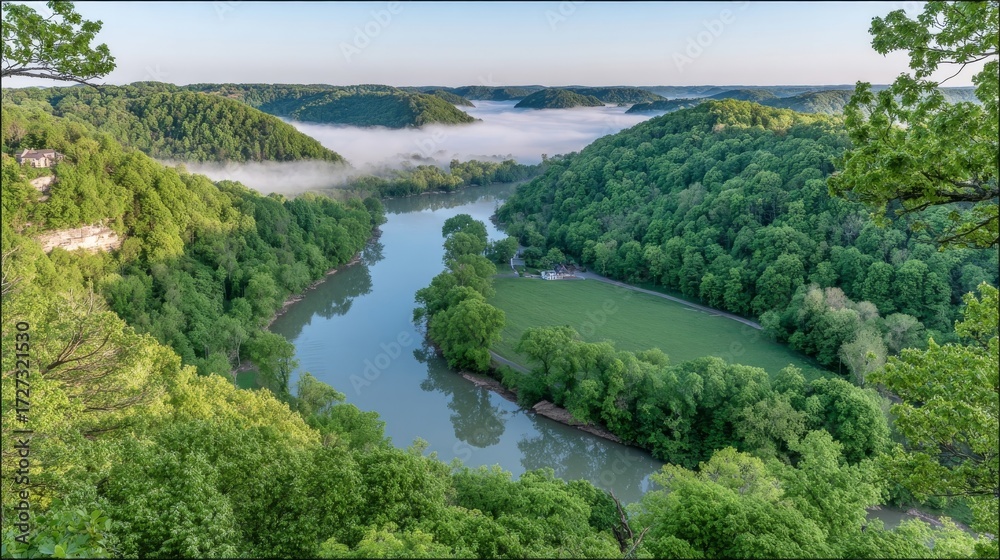 Fototapeta premium Misty river valley landscape with green hills and forest at sunrise