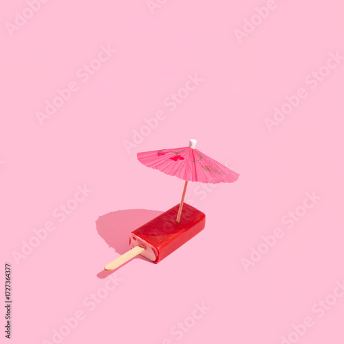 Frozen fruity ice cream bar under an umbrella, summer holidays, summer at the beach creative concept,
