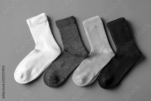 Four pairs of socks in various colors on a gray background