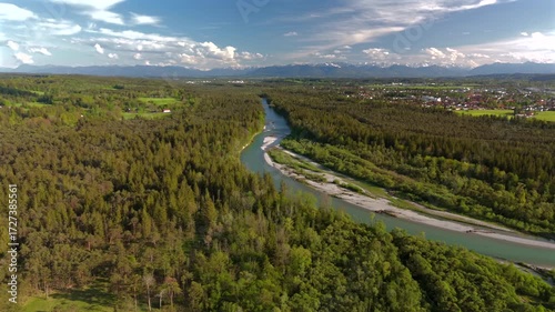 Aerial video of Isar River winding through Bavarian Alps in Germany near Wolfratshausen. Sunny day, rocky shores, forests and scenic landscapes perfect for travel, hiking and nature exploration