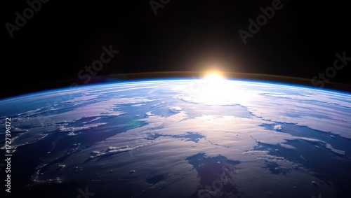 Sunrise over earth from space with a glowing horizon