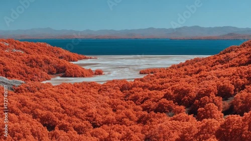 Spectacular infrared view of a mountain landscape with trees and calm blue water, serene and surreal