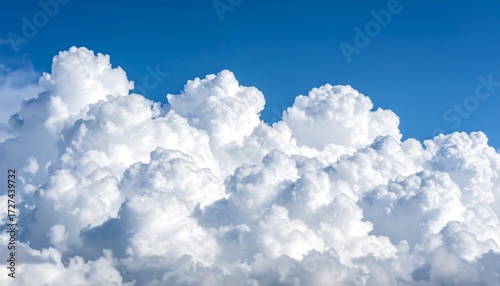 Fluffy white clouds against a vibrant blue sky