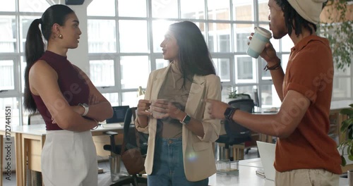 Diverse co-workers during break gathering at standing desk discussing project ideas over coffee