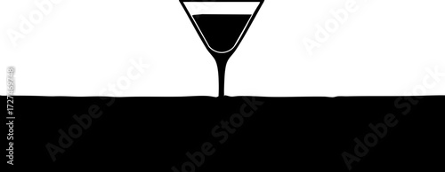 Elegant martini glass pouring dark liquid creating a bold abstract design perfect for sophisticated beverage promotions and modern branding