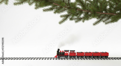 Festive christmas train set toy steam engine holiday season railroad track under christmas tree branch