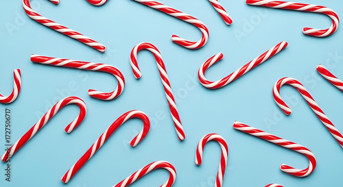 Festive Christmas candy cane pattern on a blue background, a sweet holiday tradition and celebration concept