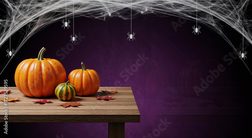 Spooky Halloween banner with assorted pumpkins on a wooden table framed by white cobwebs and spiders
