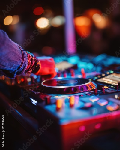 Close-up of DJ mixing music on turntable at night club, vibrant neon lights, cool atmosphere, music event, party scene, entertainment