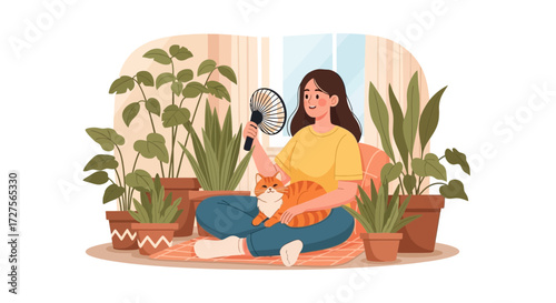 A woman sits comfortably indoors with her cat, using a fan to cool down amidst a collection of houseplants