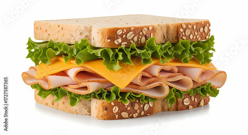 Turkey and cheese sandwich on whole wheat bread with lettuce in bright studio lighting for food photography