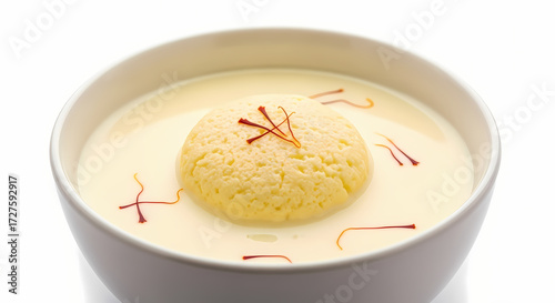 Rasgulla in Rabri with Saffron threads in creamy white lighting for Indian dessert advertising.