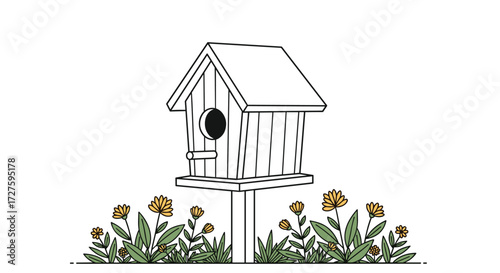 A charming wooden birdhouse stands tall amidst a bed of blooming yellow wildflowers.