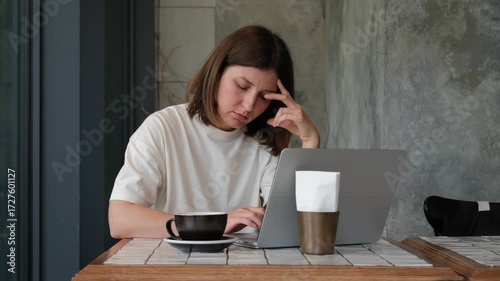 Focused Caucasian Woman Working on Laptop in Cafe