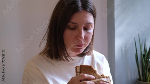 Caucasian Woman Eating Sandwich at Cafe Business Lunch