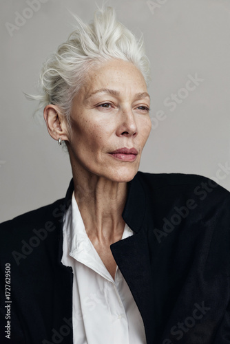 Portrait of mature stylish woman with grey hair in studio