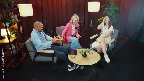 Podcast hosts engaging in lively conversation, sharing insights and anecdotes with their audience in a professional studio setting, illuminated by warm lighting and enhanced by soundproof curtains
