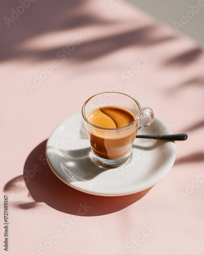 Espresso coffee in glass cup with strong shadows